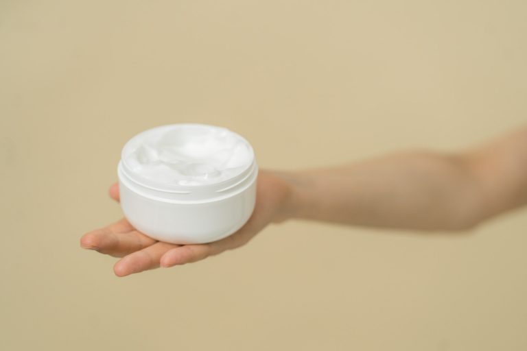 A female like hand holding a cosmetic product