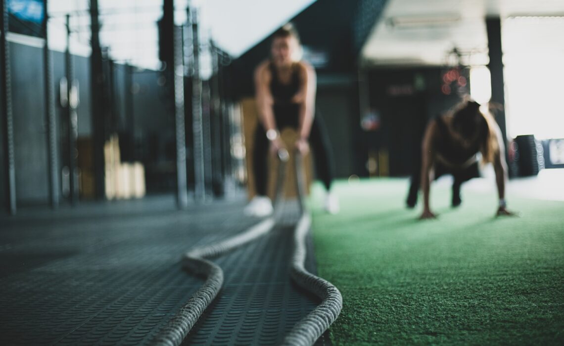 two person inside gym exercising