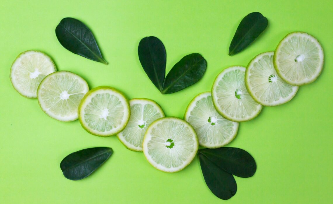 sliced lemon on green surface