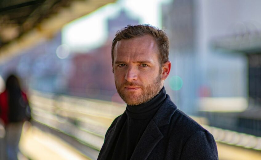 man wearing black notched lapel suit jacket
