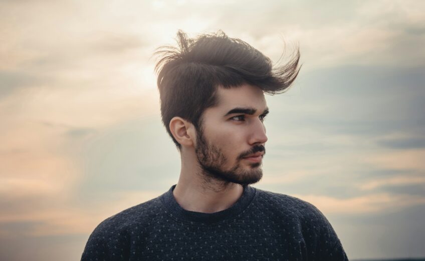 man wearing blue crew-neck top
